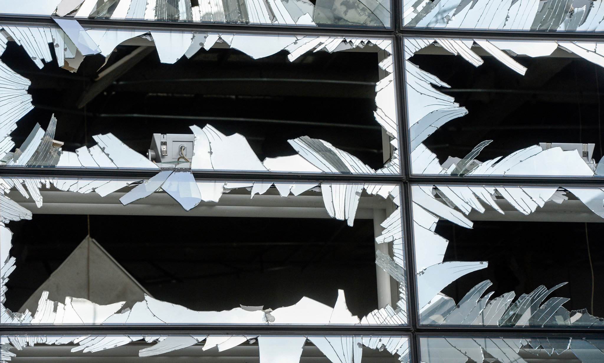 Windows at Brussels Airport after suicide bombings on Tuesday. Credit Pool photo by Frederic Sierakowski